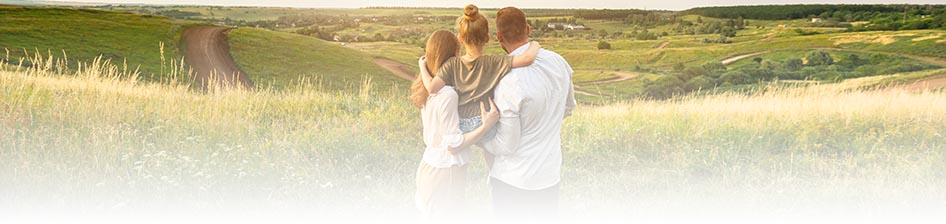 Life Page Header Banner - small family looking out over a rolling countryside